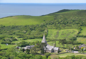 View of Llanrhystud church and hills looking towards the sea..